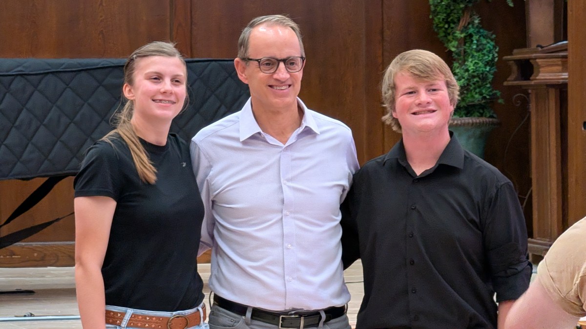 Mark Ford poses for a photo with BHS Marimba performers Madeleine Musgrove and Cooper Morgan.